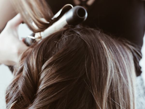 Hair being curled with a curling iron
